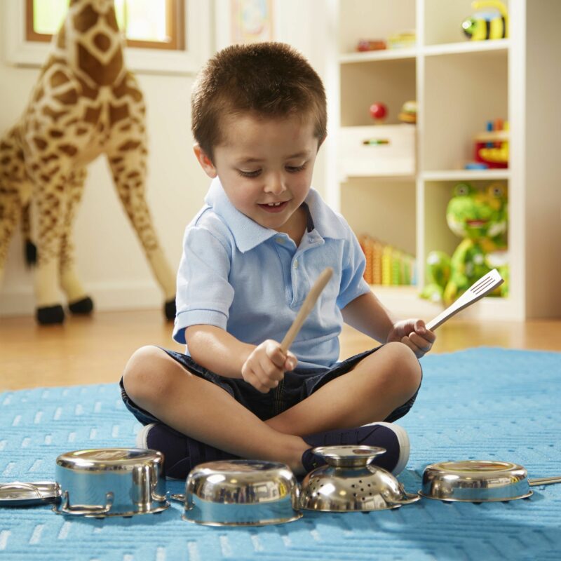 kid playing with pots and pans