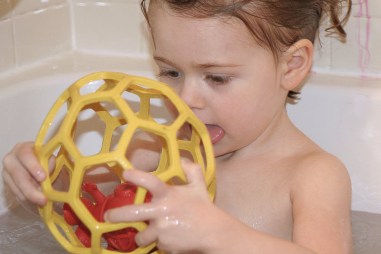 Toddler Playing With Bathtub Ball