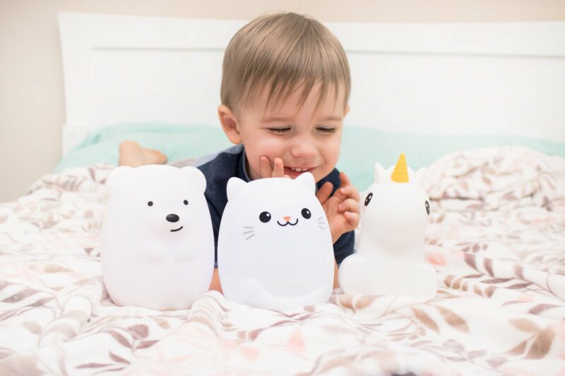 Boy Playing with LumiPets Bear, Cat, and Unicorn Nightlight with Remote