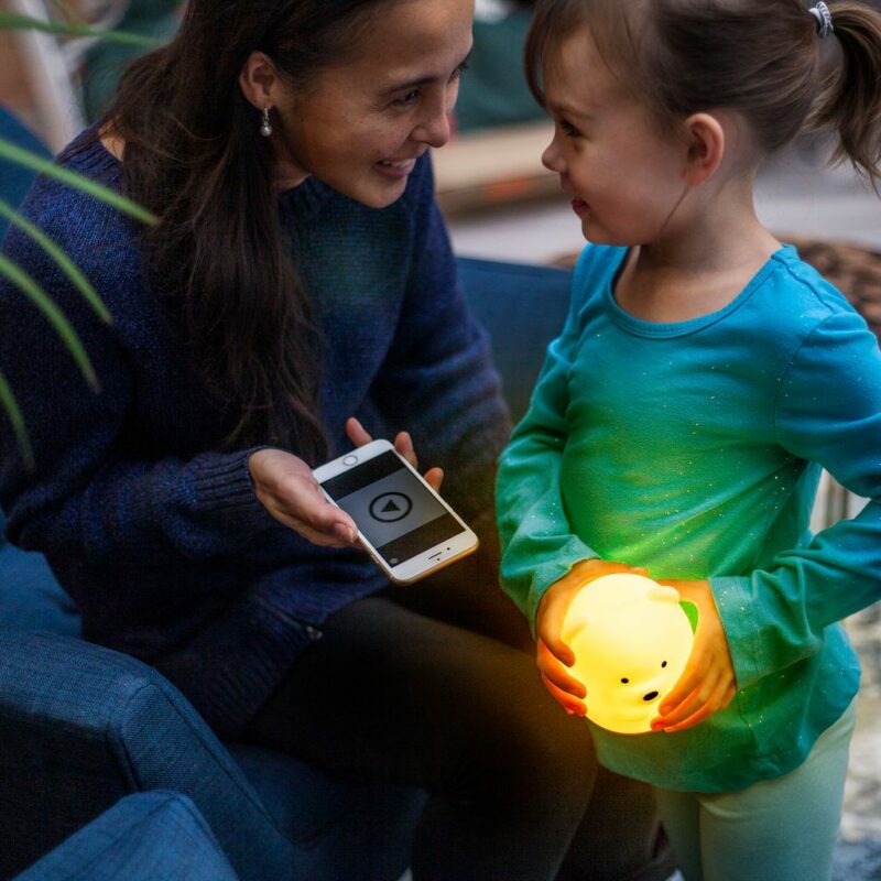 Girl Playing Music on her LumiPets Bear Nightlight with Remote and Bluetooth