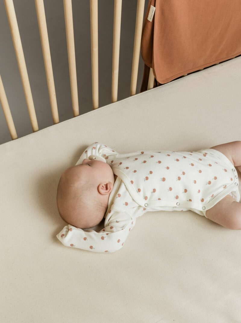 Organic Cotton Side-Snap foldover onesie with peach pattern