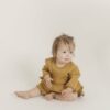 Ochre Romper with Ruffle Skirt by Quincy Mae