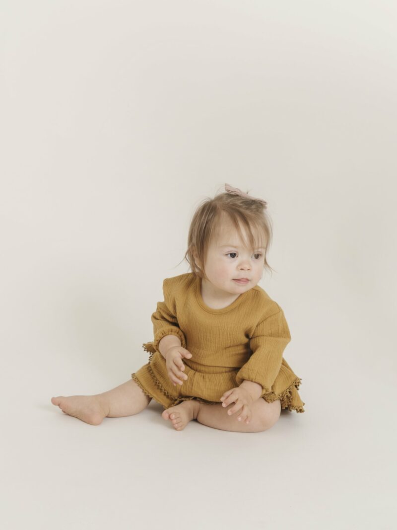 Ochre Romper with Ruffle Skirt by Quincy Mae