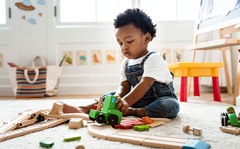 Toddler Playing with Wooden Train