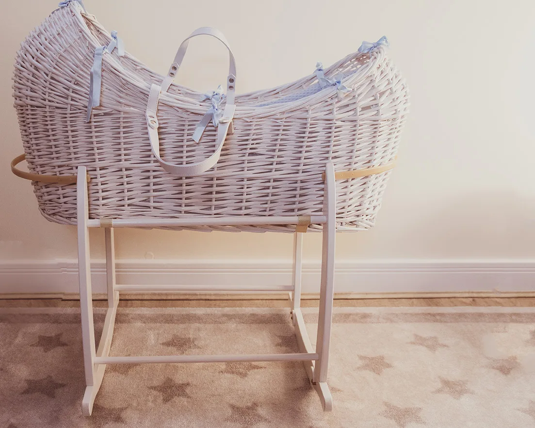 White Moses basket shown on a rocking stand