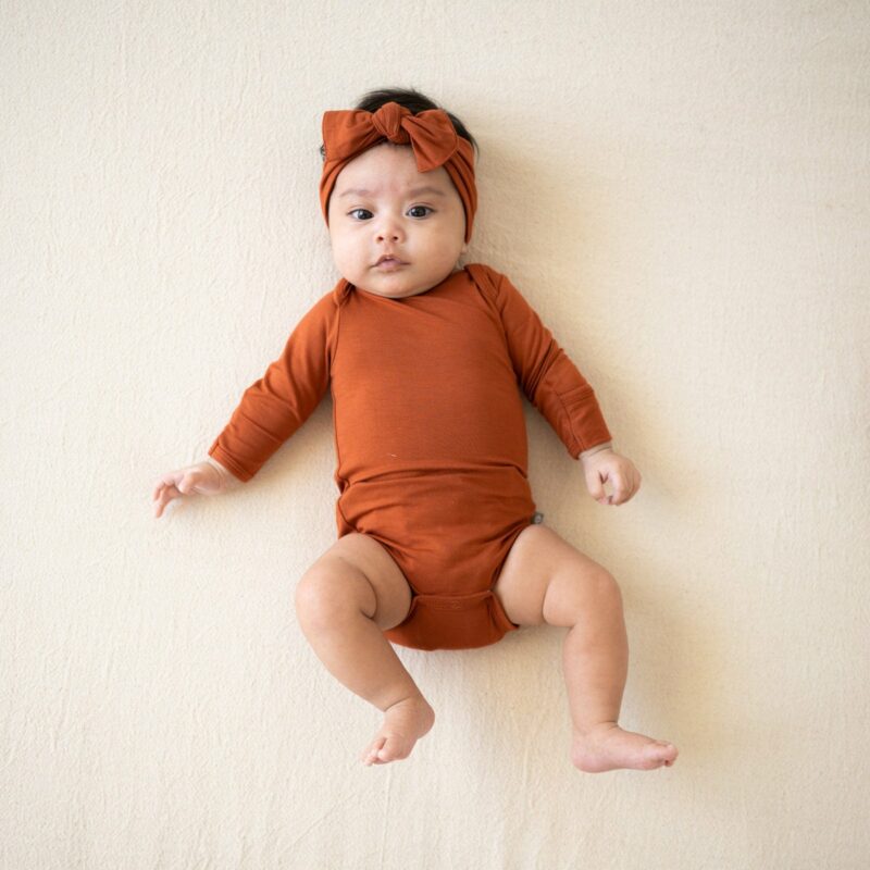 Long Sleeve Bodysuit in Rust from Kyte BABY