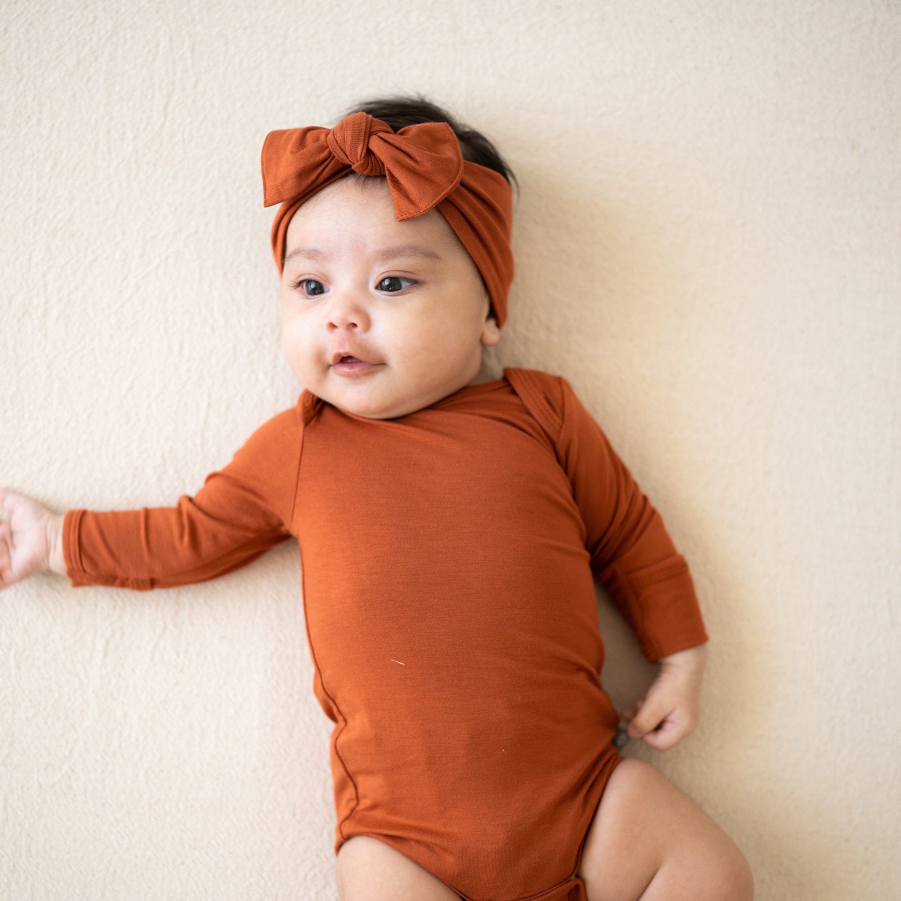 Kyte BABY Long Sleeve Bodysuit in Rust Blossom
