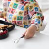Sleeved Bib: Mickey & Friends Check Mates from Bumkins