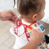 Bumkins Sleeved Bib: Mickey & Friends Check Mates Feeding